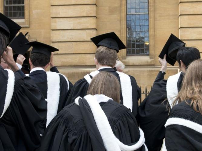Photo of students in caps and gowns entering the Sheldonian Theatre for their degree ceremony 