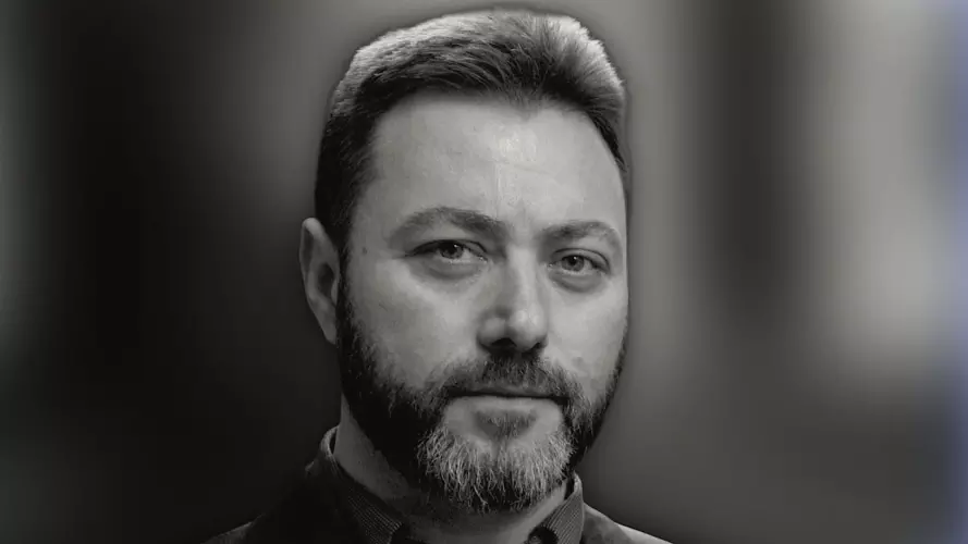 Man with beard staring at camera in black and white